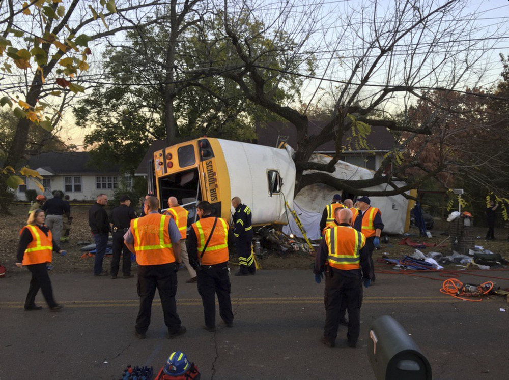 Chattanooga Fire Department personnel work at the scene of the fatal school bus crash in Chattanooga, Tenn., on Monday. Assistant Chief Tracy Arnold said there were multiple fatalities.