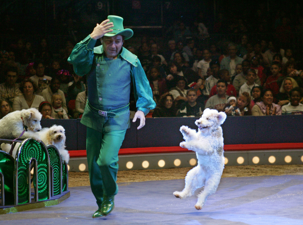 Richard Olate, of Chile, runs around the ring followed by one of his trained dogs in the Big Apple Circus at New York's Lincoln Center in 2005. The circus is filing for bankruptcy protection after four decades of entertaining the world.