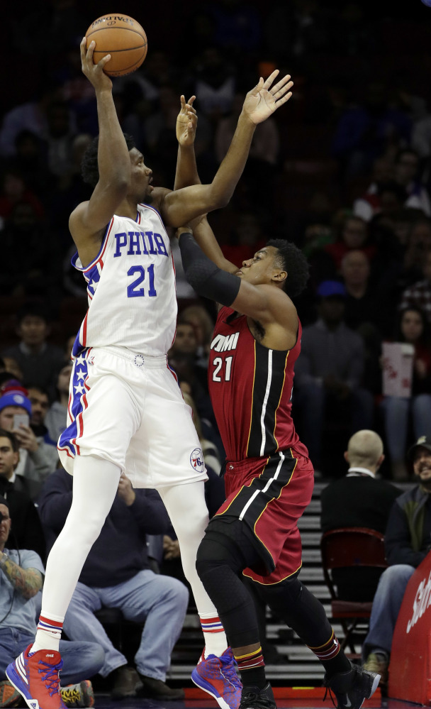 Philadelphia's Joel Embiid takes a shot while being defended by Miami's Hassan Whiteside during the 76ers' 101-94 win Monday.