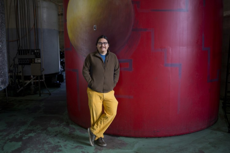 Alex Pine, the director of outreach and technology at Maine Standard Biofuels, in front of one of a recycled cooking oil tank. Pine is a College of the Atlantic grad who came to Maine from California with an interest in biofuels.