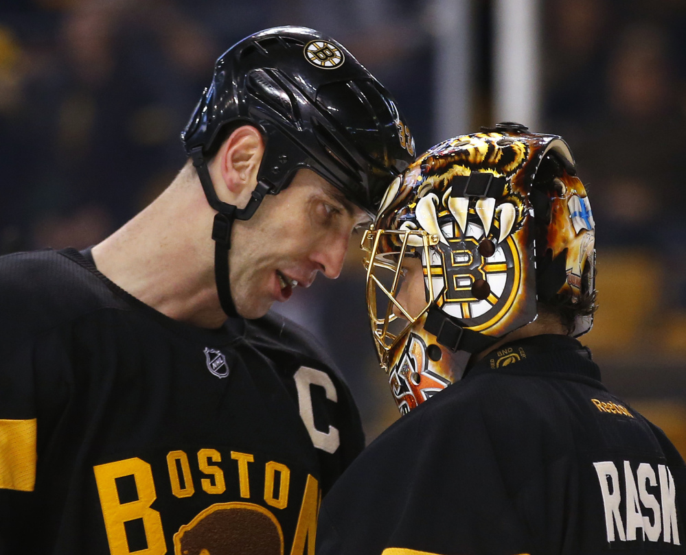 Boston Bruins goalie Tuukka Rask, right, won't have 6-foot-9 defenseman Zdeno Chara, left, to protect the crease on Thursday after Chara left Tuesday's game against St. Louis with an undisclosed injury.
