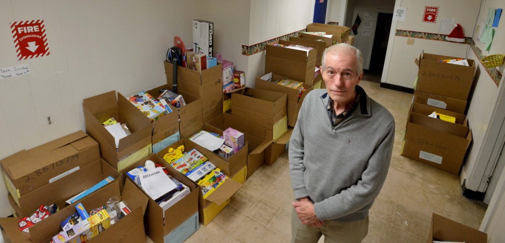 Steve Mayberry, development director at The Maine Children's Home for Little Wanderers, stands among boxes intended to be delivered to needy children for the Christmas season at the organization's home offices in Waterville.