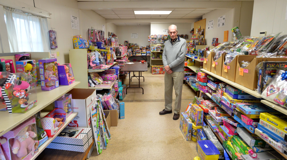 Steve Mayberry, development director at The Maine Children's Home for Little Wanderers, stands on Wednesday among presents intended to be delivered to needy children for the Christmas season at the organization's home offices in Waterville. The nonprofit said Wednesday it still needs to fill about half of its boxes to meet its goal of serving more than 1,700 children this Christmas.