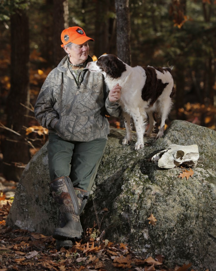 "Pink has no place in camouflage," says Georgette Kanach, a longtime hunter and Registered Maine Guide seen in the woods of Gray with her dog Star. 