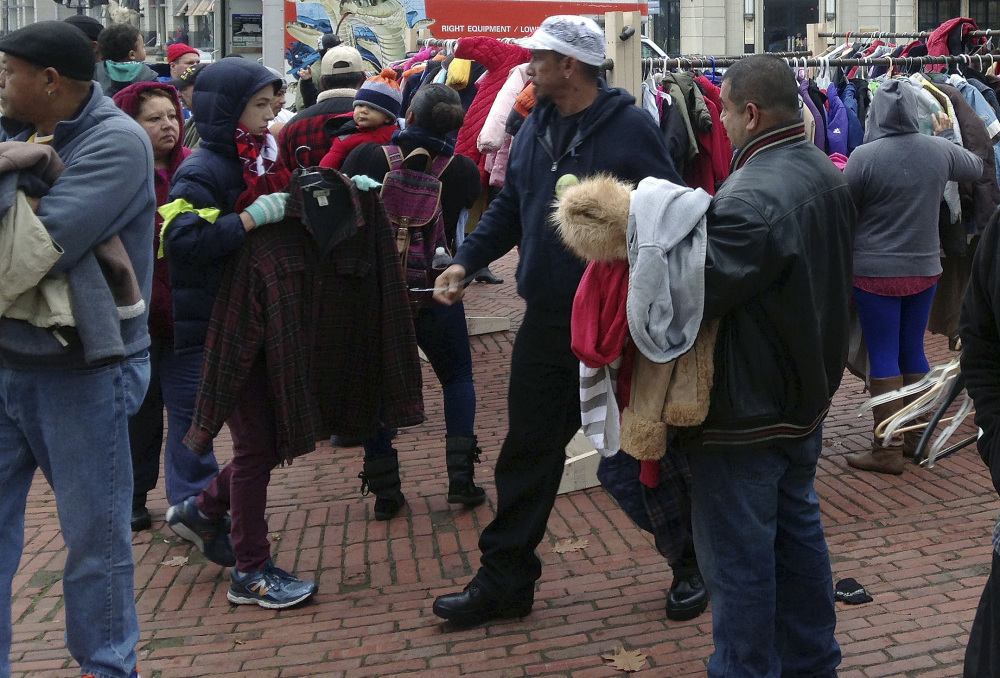 People select free winter coats Friday during the 20th annual "Buy Nothing Day" in Providence, R.I. The coat exchange is held at sites around the state on Black Friday.