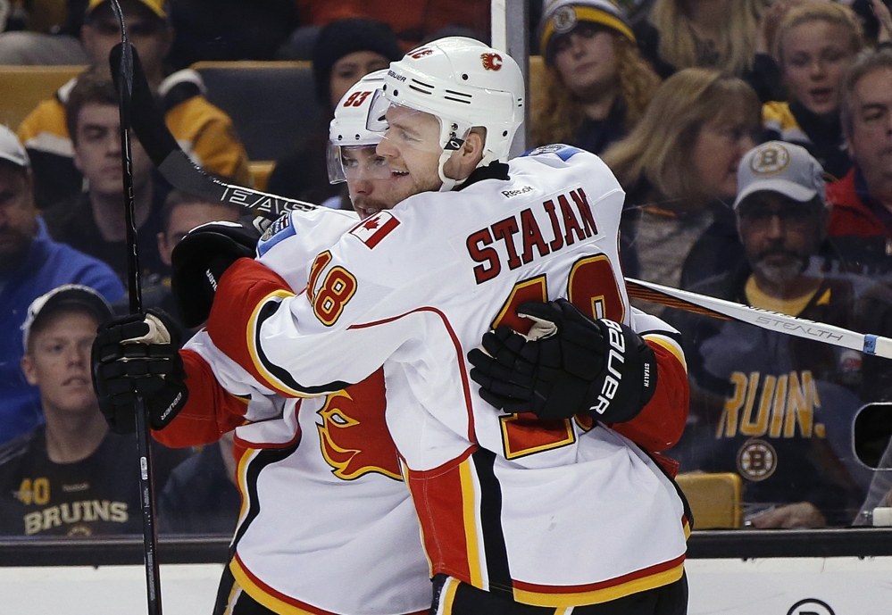 Calgary's Sam Bennett, 93, celebrates his first-period goal with Matt Stajan in Friday night's game against the Bruins in Boston. The Flames won 2-1.