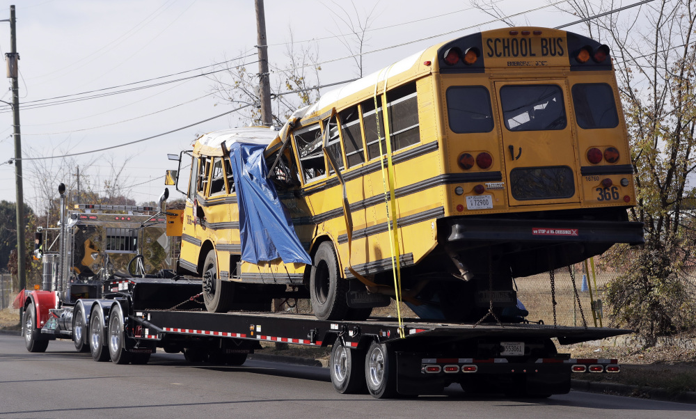 The bus that crashed Monday in Chattanooga, Tenn., is taken away from the crash site. Students and administrators raised concerns about the bus driver in the weeks before the crash, which killed six children.