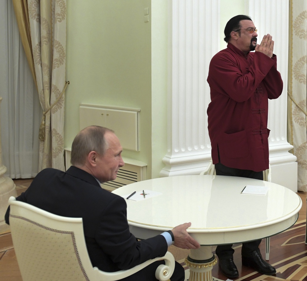 Russian President Vladimir Putin, left, hosts U.S. actor Steven Seagal in the Kremlin in Moscow, on Friday.  (Alexei Druzhinin/Sputnik, Kremlin Pool Photo via AP)