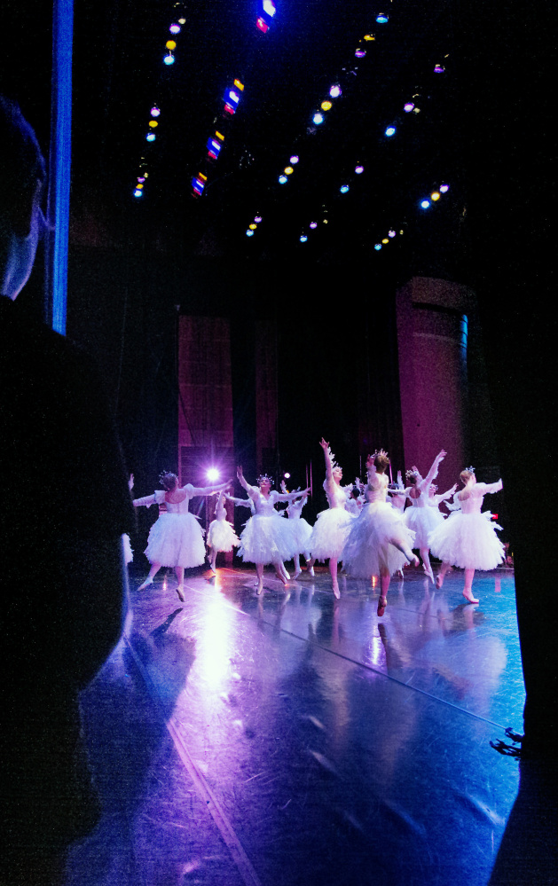 Dancers playing the parts of Snowflakes perform on a glistening stage during the dress rehearsal at Merrill Auditorium in Portland.