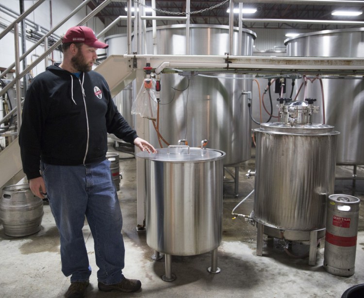 Peter Heggeman, head brewer at D.L. Geary Brewing Co., is shown in November with the brewing system that makes small craft batches for Geary's tasting room. The company is being sold to a Freeport businessman after more than 30 years of ownership by the Geary family.
