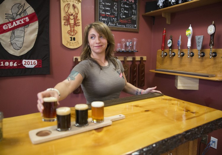 Danielle Coons, tasting room ambassador at Geary's, pours a beer brewed using the small-batch pilot brewing system. 