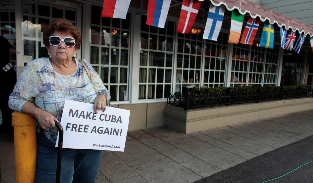 Caridad Hernandez holds a sign in front of the popular Cafe Versailles a day after the announcement of the death of former Cuban leader Fidel Castro in the Little Havana district of Miami on Sunday.