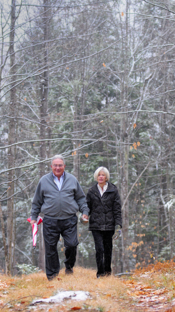 John and Lisa Rosmarin stroll Friday in Readfield on land their family donated to the Kennebec Land Trust.
