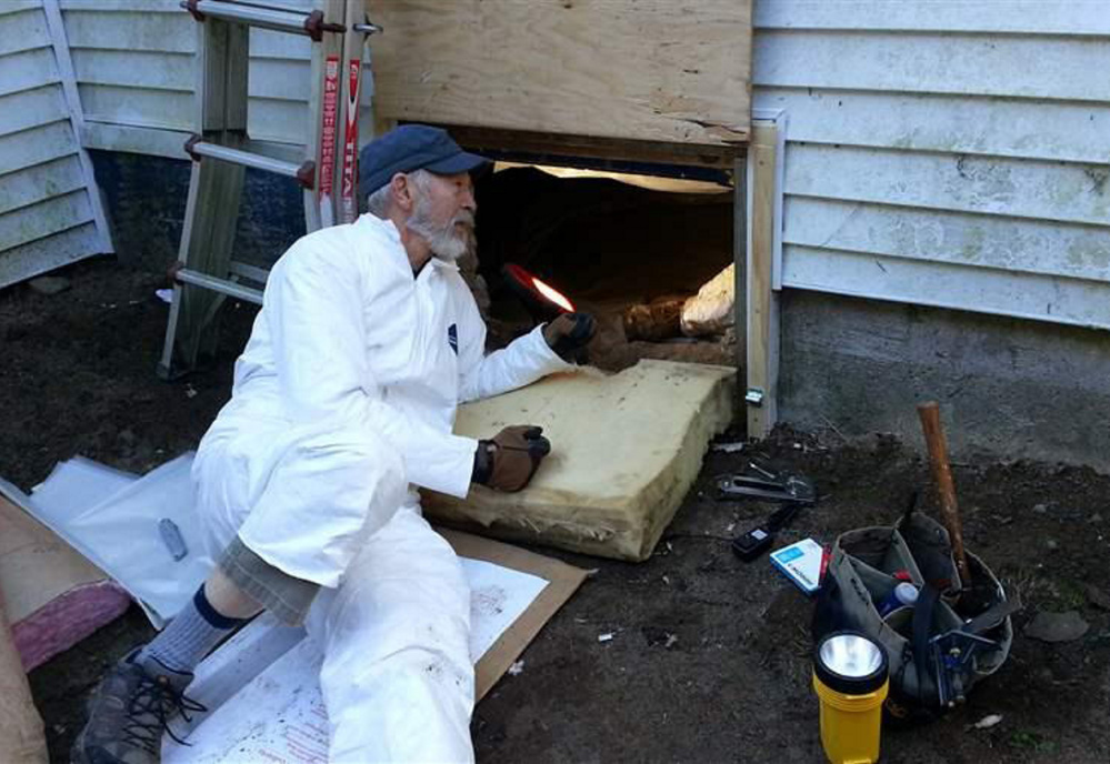 Dave Brown, 75, a volunteer for the Harpswell Aging at Home team, insulates the floor under a house. Volunteers are helping seniors remain in their homes, but there should be other options, as well.