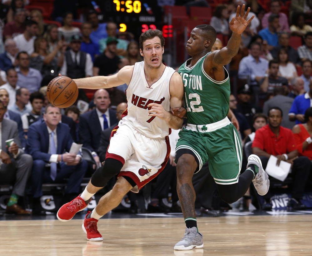 Miami Heat guard Goran Dragic drives to the basket against Celtics guard Terry Rozier in the first half of Boston's win Monday night in Miami.