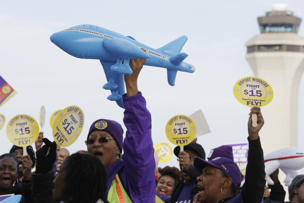 Airport workers rally for an increase in the minimum wage on Tuesday at the Detroit Metropolitan Airport in Romulus, Mich. Fast-food restaurant workers as well as home and child-care workers protested nationally.