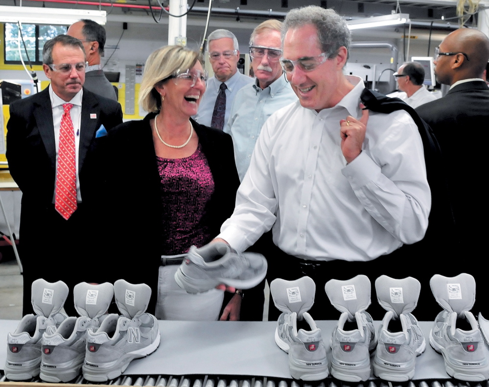 U.S. Trade Representative Michael Froman examines a sneaker at the New Balance plant in Norridgewock during a tour in 2013. Company CEO Rob DeMartini, left, plant Manager Raye Wentworth, then-U.S. Rep. Mike Michaud and U.S. Sen. Angus King accompany him.