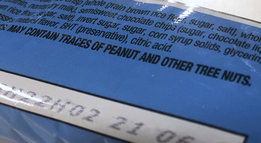 Part of a food label states the product "may contain traces of peanut and other tree nuts." A new report says the hodgepodge of warnings that a food might accidentally contain a troublesome ingredient is confusing to people with food allergies, and calls for a makeover.