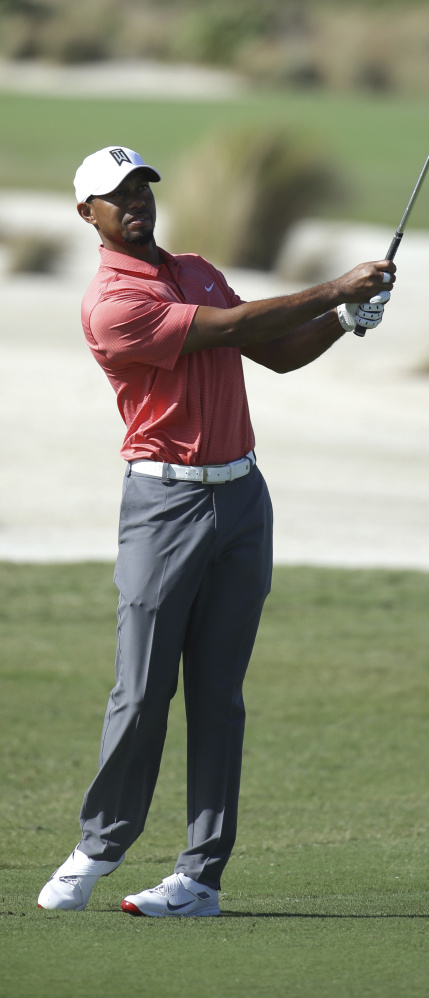 Tiger Woods hits from the sixth fairway during the pro-am at the Hero World Challenge golf tournament Wednesday. Woods is in his first tournament in 15 months.
