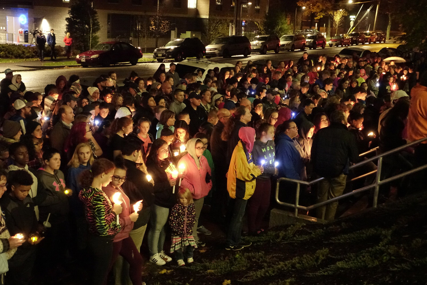 A crowd gathers in Lewiston on Thursday night for a vigil for Jayden Cho-Sargent, an eighth-grader who was killed Thursday morning while crossing Main Street about a block from his home.
