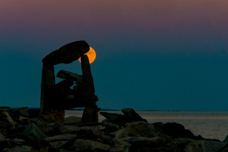 The supermoon is seen Sunday night  from the back shore of Peaks Island in Casco Bay. Ben McCanna/Staff Photographer