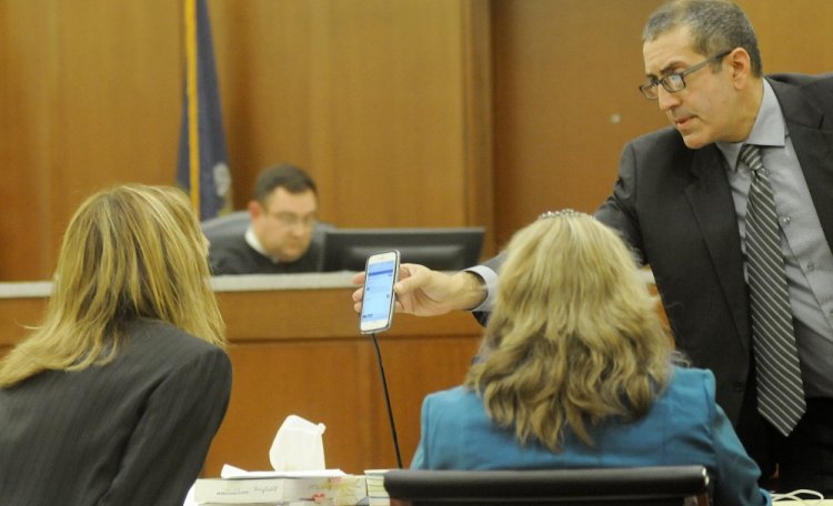 Defense attorney Charles Ferris shows Assistant District Attorney Tracy DeVoll a message Tuesday on Danielle Jones' cellphone during Jones' trial in Augusta. 