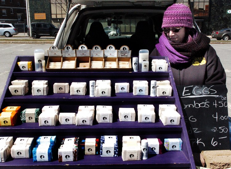 Joanne Gorey sets out soaps from her A Page N Thyme Farm and Soap shop at the downtown Waterville farmers market. Many of Maine’s soapmakers use ingredients from their farms to make their soaps.


