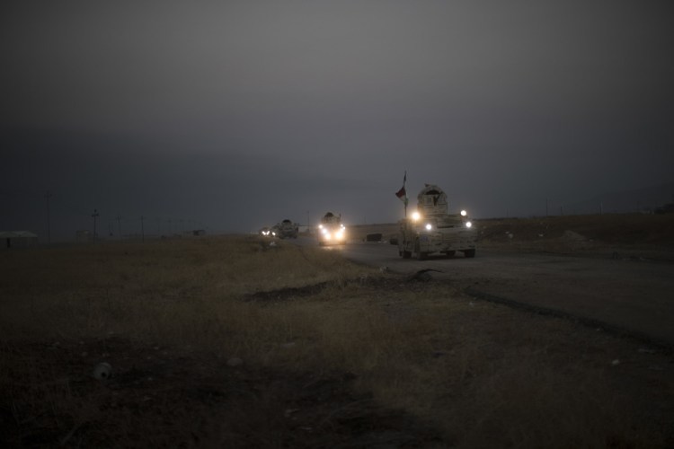 A Kurdish Peshmerga convoy drives toward a front line in Bashiqa, east of Mosul, Iraq, on Monday. (AP Photo/Felipe Dana)