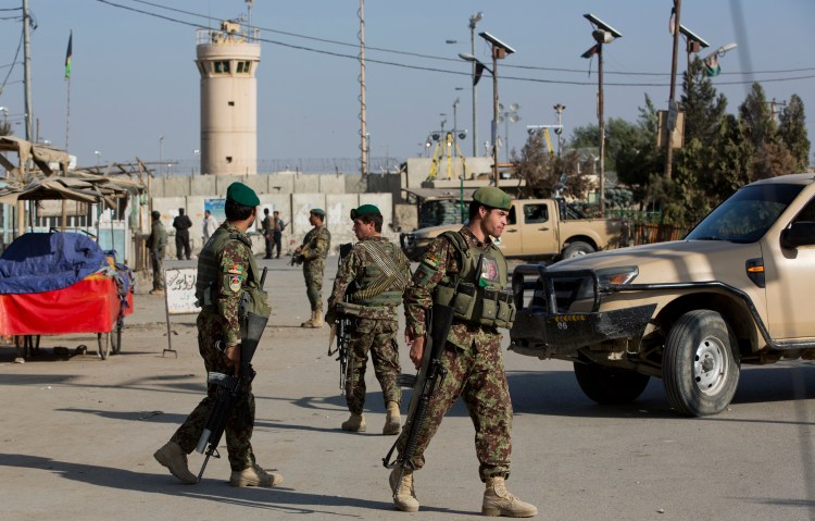 Afghanistan's National Army soldiers guard the main road to the Bagram Airfield's main gate in Afghanistan on Saturday.