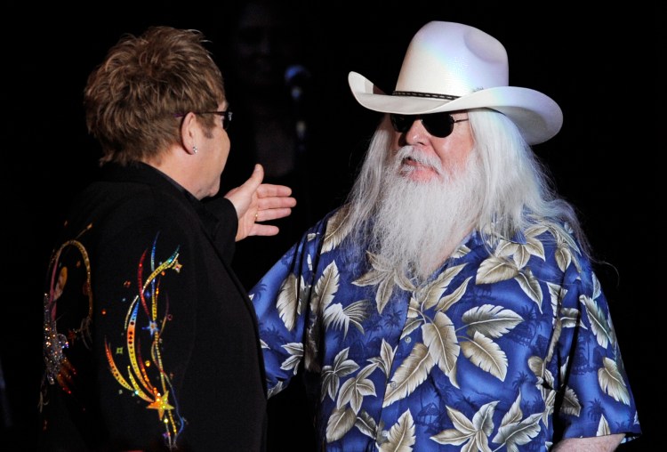 Leon Russell greets Elton John onstage during their joint concert at the Hollywood Palladium in Los Angeles on Nov. 3, 2010.