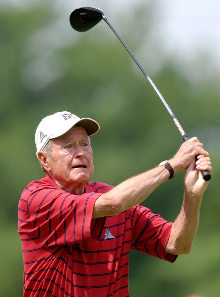 Former U.S. President George H.W. Bush watches his tee shot while playing golf in 2007. Several of his golf items were sold at auction for $30,000 this week.