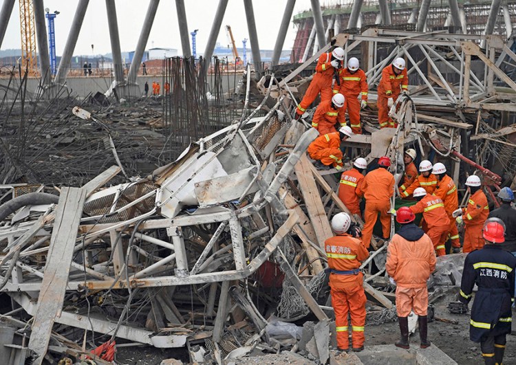 Rescue workers look for survivors after a work platform collapsed at the Fengcheng power plant in eastern China's Jiangxi Province on Thursday <em>Wan Xiang/Xinhua via AP</em>