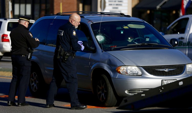 Portland police examine a car after a pedestrian was hit on Forest Avenue on Tuesday morning. 