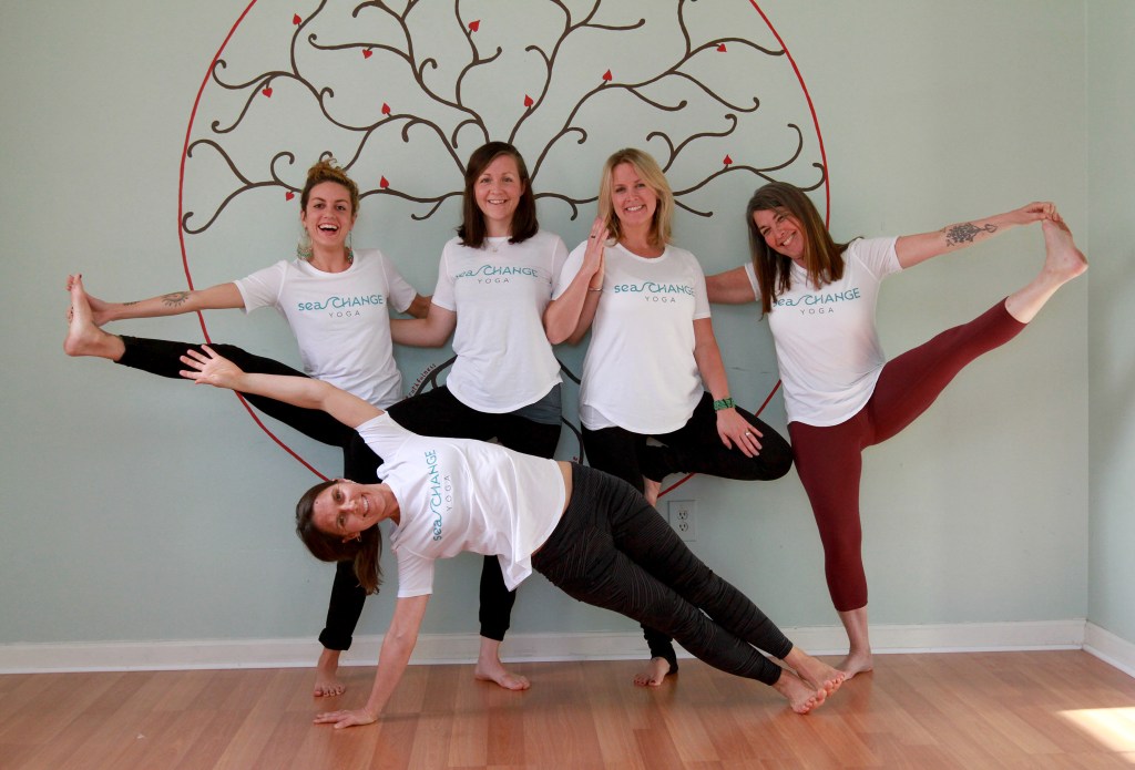 Board members and yoga instructors at Sea Change Yoga in Portland loosen up. From left, top row are Jennie Tavares, Lee Sowles, Melea Nallli and Diana Lee.  In front is Jen Queally. (Staff photo by Melanie Sochan.)