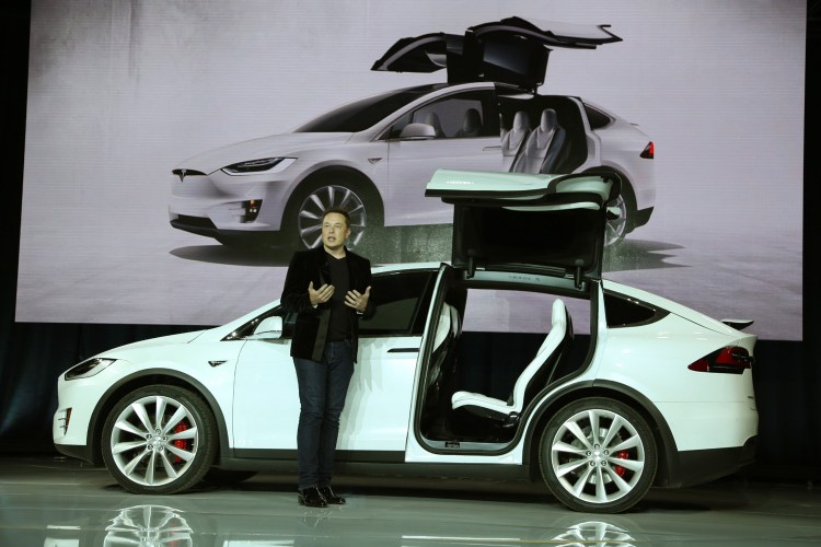 Tesla CEO Elon Musk introduces the falcon wing door on the Model X electric sports-utility vehicle in September 2015.