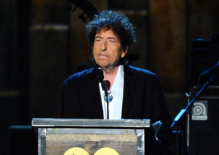 Bob Dylan, shown here accepting the 2015 MusiCares Person of the Year award in Los Angeles, won't travel to Stockholm to receive the Nobel Prize for Literature on Dec. 10, but he is still required to deliver a Nobel lecture within six months of that date. Vince Bucci/Invision/AP