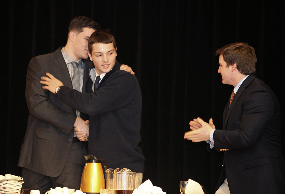 Joe Esposito of Portland High, center, is congratulated by fellow finalists Austin McCrum of Thornton Academy, left, and Will Bessey of Brunswick after he was awarded the 45th James J. Fitzpatrick Trophy during a ceremony in Portland on Jan. 24. Eleven semifinalists were announced Wednesday for this season's Fitzpatrick Trophy. <em>Jill Brady/Staff Photographer</em>