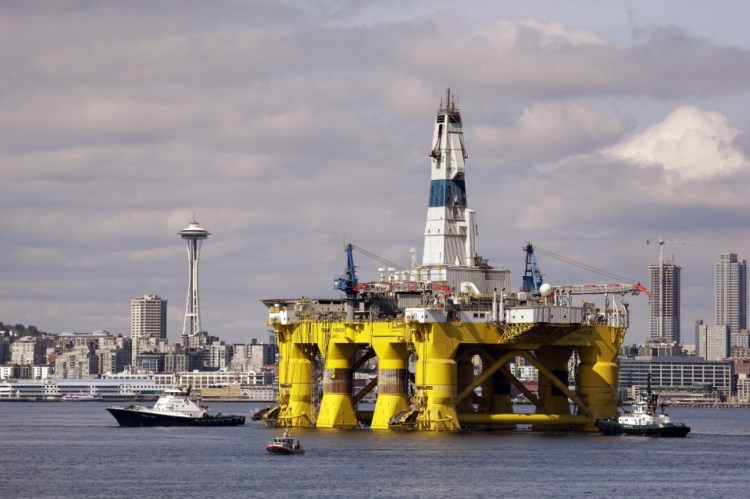 The Royal Dutch Shell oil drilling rig Polar Pioneer is towed toward a dock in Elliott Bay in Seattle in May 2015. Royal Dutch Shell walked away from exploratory drilling in U.S. Arctic waters, and the Obama administration has taken steps to keep drill rigs out of Alaska’s northern ocean for years to come. <em>Associated Press/Elaine Thompson</em>
