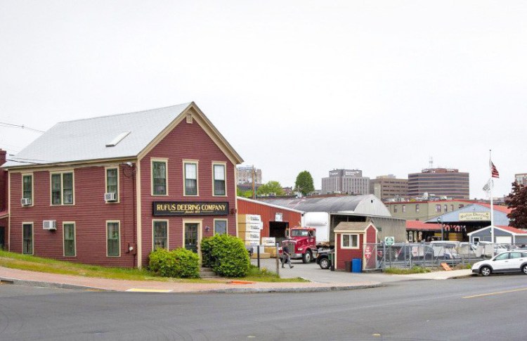 A photo taken in June shows Rufus Deering Lumber Co. on Commercial Street, with downtown Portland in the background. <em>Derek Davis/Staff Photographer</em>