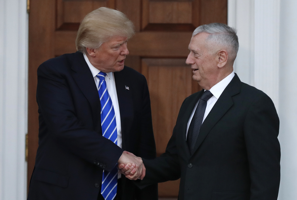 President-elect Donald Trump shakes hands with retired Marine Corps Gen. James Mattis on Nov. 19 as he leaves Trump National Golf Club Bedminster clubhouse in Bedminster, N.J. Trump said at a rally Thursday that he will nominate Mattis as defense secretary.