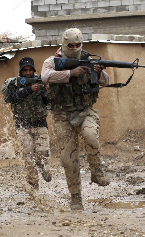 Iraqi soldiers secure streets in a village recently liberated from Islamic State militants.