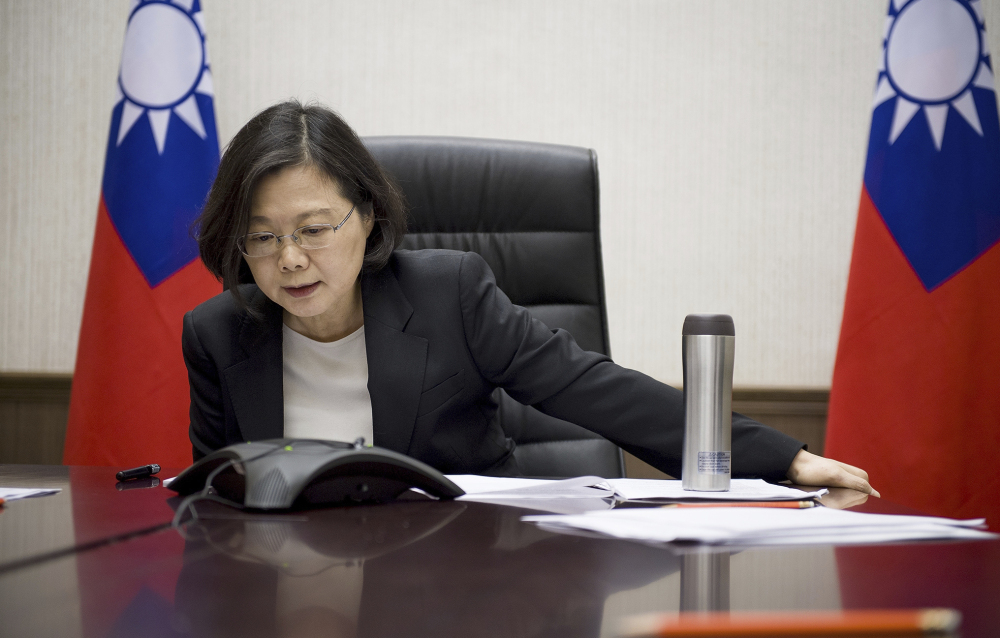 In this photo released by the Taiwan Presidential Office, Taiwan's President Tsai Ing-wen speaks with U.S. President-elect Donald Trump through a speaker phone in Taipei on Friday. The call was a breach of protocol as the U.S. government recognizes Taiwan as a part of China.