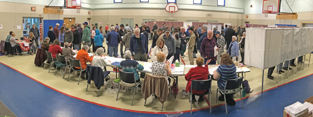 Voters wait in line to cast ballots at the Boys and Girls Club of Greater Gardiner in this Nov. 8 file photo. A Gardiner city council candidate says the club may have jeopardized its nonprofit status by publicly backing another candidate for council.