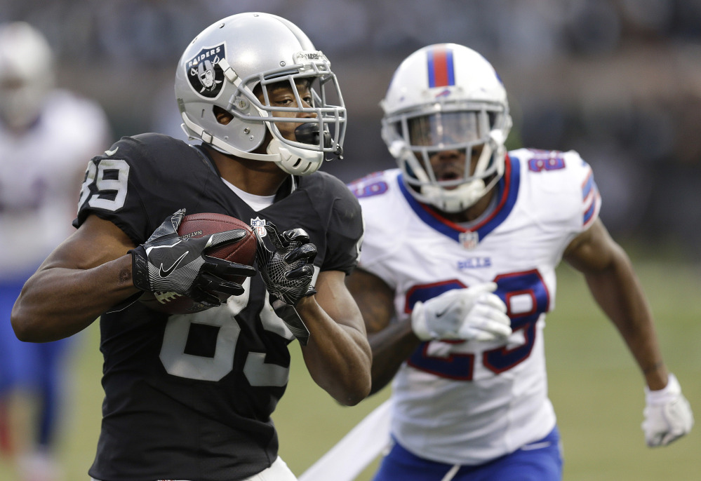 Amari Cooper of the Oakland Raiders runs past Kevon Seymour of the Buffalo Bills to score on a 37-yard pass play Sunday during Oakland's 38-24 victory at home.