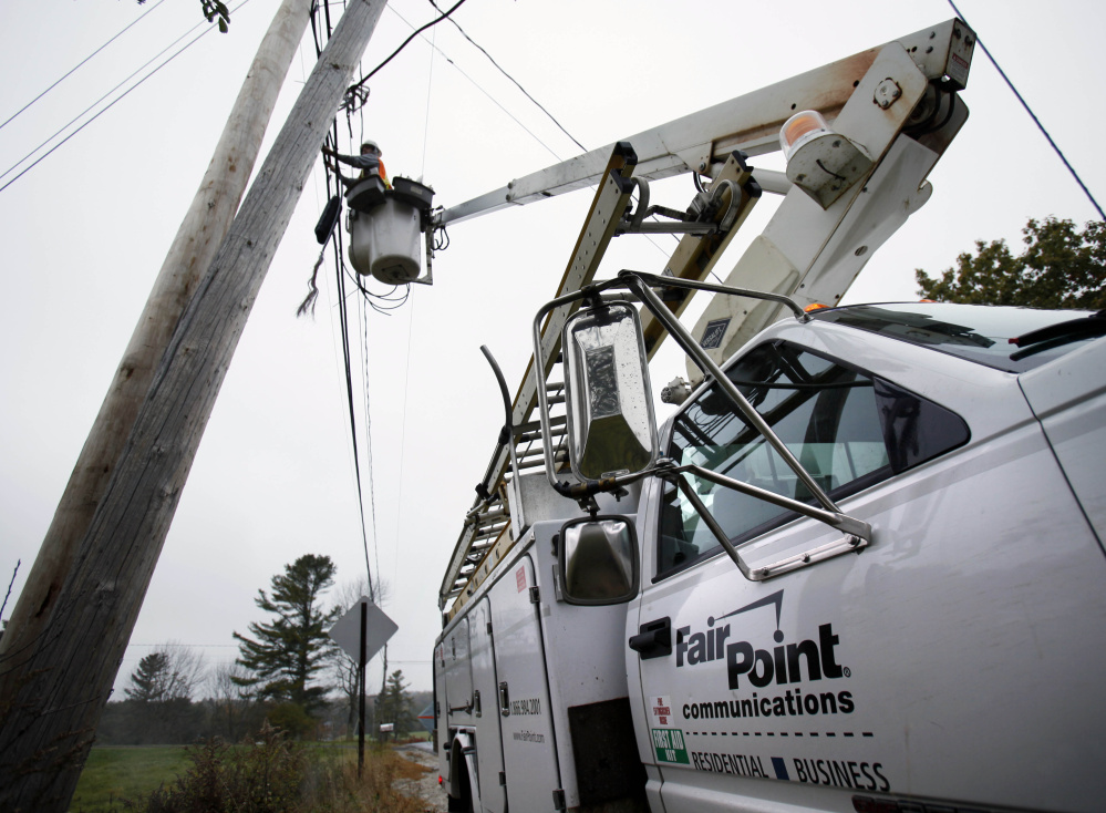 Peter Adams, a telephone line splicer for FairPoint Communications, works from a bucket lift in Freeport in October 2009.