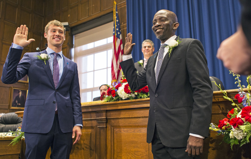 Newly elected City Councilors Brian Batson, left, and Pious Ali are sworn in during a ceremony Monday at City Hall. It is "probably the most diverse council in Portland history - maybe Maine history," Mayor Ethan Strimling said. The nine councilors range in age from 25 to 65.