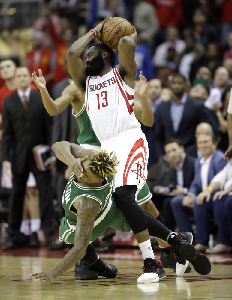 The Celtics' Marcus Smart falls to the floor on a flagrant foul by the Rockets' James Harden late in the fourth quarter. Smart made two free throws on the foul but the Rockets held on to win, 107-106.