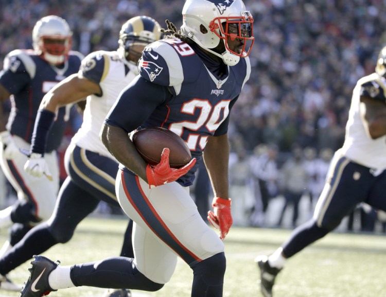 New England Patriots running back LeGarrette Blount runs for a touchdown against the Los Angeles Rams on Sunday. Blount has rushed for 957 yards and 13 touchdowns this season.