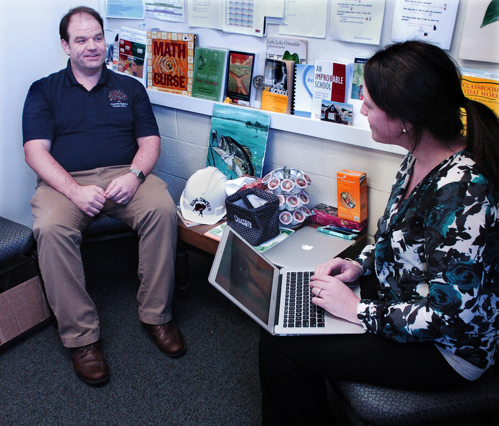 Cornville Regional Charter School Principal Travis Works and learning facilitator Susan Muzzy confer in an office Tuesday.