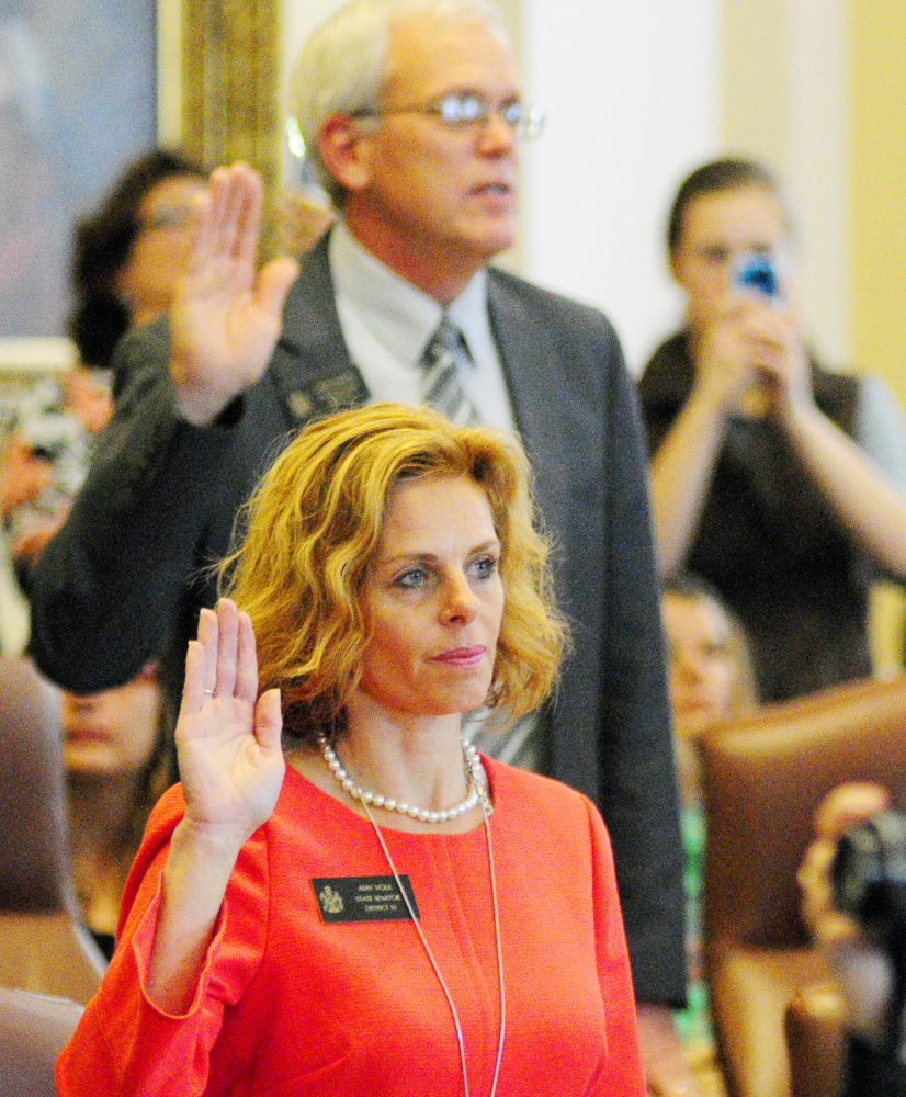 Elected Sens. Scott Cyrway, R-Benton, and Amy Volk, R-Scarborough, are sworn in Wednesday by the governor.